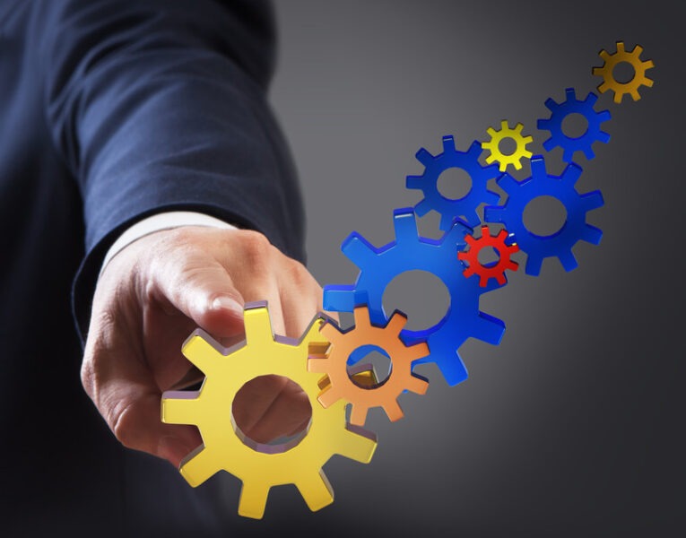 hand pointing to gears