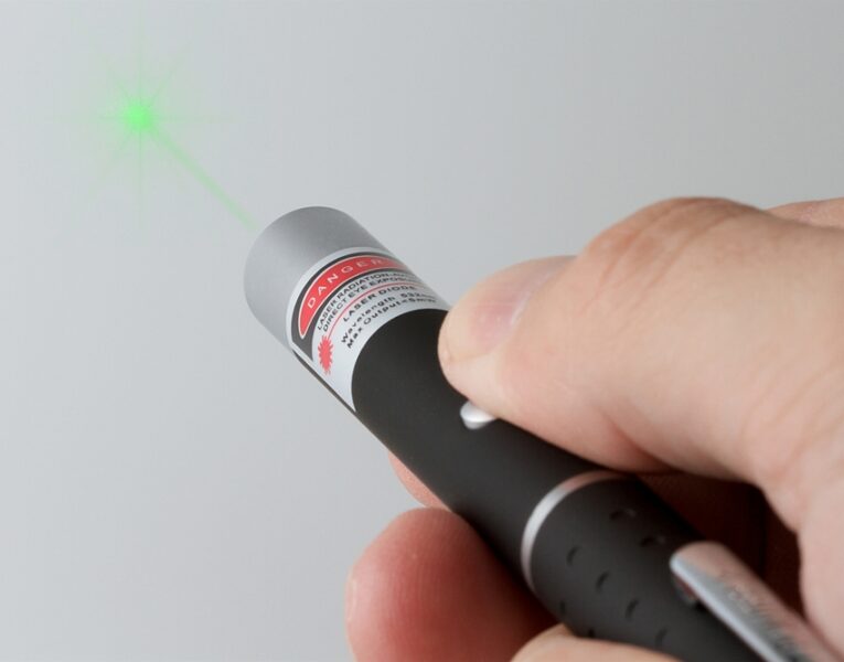 handing holding green laser pointer